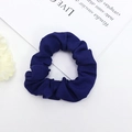 Detail of a dark blue pleated fabric scrunchie on a stylish white and floral background - Navy Blue (3)