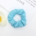 Détail d'un chouchou en tissu bleu ciel avec plis délicats sur un fond de style épuré - Bleu Ciel (9)