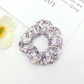 Detail of fabric scrunchie with purple floral pattern on a white background cloth - Purple Floral