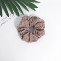 Detailed close-up of brown houndstooth fabric scrunchie with soft pleated texture - Reddish Brown (No. 1 Color)