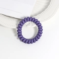 Detailed macro view of a matte purple spiral phone wire hair tie on white background - Color 3