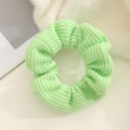 Detail of light green knitted scrunchie with soft honeycomb texture and elastic design - Green