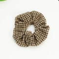 Detailed view of vintage houndstooth fabric texture on a brown and beige scrunchie - Yellow