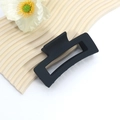 Macro detail of large matte black hollow shark hair claw clip on wavy display board - Rectangular Hollow Style
