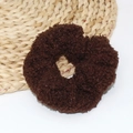 Macro shot of dark brown teddy fleece hair scrunchie with soft fluffy texture on straw mat - Dark Coffee