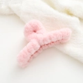 Detail view of light pink plush hair claw clip with faux rabbit fur on soft white background - Pink