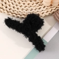 Fuzzy black faux shearling claw clip for thick hair displayed on a cozy background - Black
