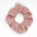 Close-up of pink velvet scrunchie showing fine grid texture and elastic fabric detail - Pink