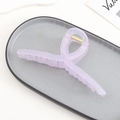 Macro detail of lavender acrylic hair claw clip with golden metal spring mechanism - Light Purple