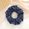 Detailed macro view of navy blue floral chiffon scrunchie with white flower patterns - Dark Blue