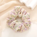 Detail of light yellow floral scrunchie with purple patterns on soft chiffon fabric - Yellow