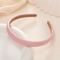 Pink glossy leather headband for women with non-slip lining on a white ceramic plate - Pink