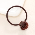 Close-up of elegant dark red resin rose hair tie with high-elasticity coffee nylon band - Brown