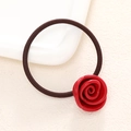 Detailed close-up of a red resin rose hair tie with a durable elastic band on a white plate - Red
