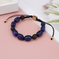 Detail of adjustable woven lapis lazuli and lava stone yoga bead bracelet with gold clasp - Oval Lapis Lazuli