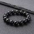 Minimalist black obsidian beaded bracelet on dark rock background for men and women - Large