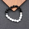 Tiger eye crystal faceted bead bracelet with stainless steel accents on wood background - Faceted Black Agate & White Turquoise