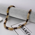 Handgemaakte boho ketting met gele natuursteen en bruine kralen van kokoshout - Citrien & Kokosnootschil