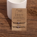 Close-up of luminous heart beads on adjustable friendship bracelets on gift card - Luminous Purple Heart