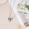 Close-up of polished silver heart-shaped couple necklaces with Forever engraving - Silver