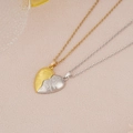 Detail of magnetic heart pendants with matte texture and embossed hand-holding design - Gold White