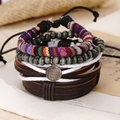 Detail of vintage hand-woven leather bracelet set with silver medal on retro magazine - Saint Benedict Medal Metal Disc (BN-0129-2)