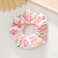 Dettaglio dell'elastico per capelli con stampa floreale rosa e bordino verde sottile - Floreale Rosa Arancio Bordo Verde