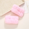 Detailed view of pink plush absorbent wristbands for washing face in soft coral fleece - Pink