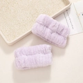 Close-up of soft purple coral fleece wristbands for washing face to prevent water splashes - Purple