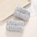 Macro shot of gray plush wristbands in coral fleece texture for face washing and skincare - Grey