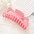 Close-up of large pink matte claw clip with geometric cutout on white textured background - Matte Pink (7#)