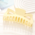 Macro view of a large matte cream hair claw clip with a stylish geometric cutout design - Matte Milk Yellow (9#)