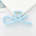 Close-up of light blue hair claw clip with cross-line design and metallic spring detail - Blue
