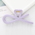 Detailed close-up of light purple heart-shaped hollow bow hair clip with golden metal spring - Purple