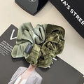 Dettaglio di un elastico verde oliva con texture miste in seta e velluto morbido - Verde