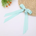 Close-up of mint blue double-layered satin bow hair clip with long flowing ribbons - Lake Blue