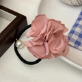 Detail of pink fabric flower hair tie with a small pearl on a black elastic band - Pink