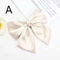 Detail view of champagne gold satin bow hair clip with elegant glossy fabric texture - Satin Bow (Beige)