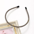 Detailed view of thin sparkling rhinestone headband with dark gray crystals on white background - Gray