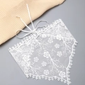 Dettaglio di un foulard in pizzo bianco con ricamo floreale e bordi smerlati - Stile Pizzo Piccoli Fiori