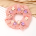 Detail of pink mesh hair scrunchie with delicate 3D floral accents and green leaves - Pink