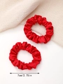 Macro detail of two red satin scrunchies with silver rhinestones and 7cm size measurement - Red
