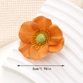 Close-up of 5cm orange fabric flower hair clip with yellow stamen and soft texture detail - 5cm Style / Orange