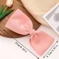 Pink fabric oversized bow hair clip measuring 21cm by 9.7cm for sweet feminine styling - Pink