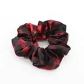 Detailed view of large leopard scrunchie with red marble pattern and satin finish - Red