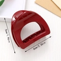 Detailed view of deep red glossy hair claw clip with size dimensions 5cm by 6cm - Burgundy