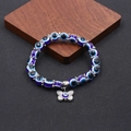 Dettaglio delle perline occhio di Allah e del ciondolo a farfalla in argento sul bracciale - Stile Farfalla (BNS-0222-8MM)