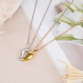 Close-up of magnetic heart-shaped couple necklaces in gold and silver finish - Gold & Silver Splicing (NST-0213-5)