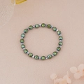 Detail view of faceted metallic green beads and silver geometric spacers on an elastic bracelet - Metallic Green Faceted Beads with Silver Spacers Style (BNS-0217-1)