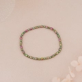 Detailed macro view of colorful hematite beads with rainbow metallic coating on pink background - Aurora Rainbow Oval Beads Style (BNS-0217-4)